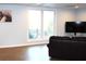 Spacious living room features a large window, modern decor, and hardwood floors at 1247 Monroe Ne Dr, Atlanta, GA 30306