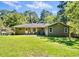 Back exterior view of charming home with well-maintained lawn at 3087 Meadow Lark Ln, East Point, GA 30344