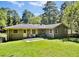 Back exterior view of charming home with well-maintained lawn at 3087 Meadow Lark Ln, East Point, GA 30344