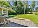 Spacious backyard with mature trees, green lawn, and patio area at 3087 Meadow Lark Ln, East Point, GA 30344