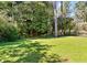 Lush backyard with mature trees providing shade and privacy at 3087 Meadow Lark Ln, East Point, GA 30344