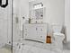 Bathroom featuring a marble vanity, glass enclosed shower, and modern fixtures, creating a luxurious and stylish space at 3087 Meadow Lark Ln, East Point, GA 30344