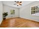 Sunlit bedroom featuring hardwood floors and windows with backyard views at 3087 Meadow Lark Ln, East Point, GA 30344