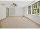Bright bedroom featuring neutral walls, carpet, ceiling fan, and windows allowing lots of natural light at 3087 Meadow Lark Ln, East Point, GA 30344
