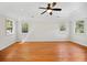 Bright bedroom with hardwood floors, offering ample natural light from multiple windows, creating a warm and inviting space at 3087 Meadow Lark Ln, East Point, GA 30344