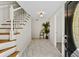 Welcoming foyer featuring a staircase with wood treads and modern tile flooring at 3087 Meadow Lark Ln, East Point, GA 30344