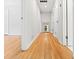 Hallway featuring beautiful hardwood floors, neutral walls, and access to multiple rooms, creating a bright and spacious feel at 3087 Meadow Lark Ln, East Point, GA 30344