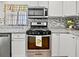 Kitchen featuring granite countertops, stainless steel appliances, and white cabinets at 3087 Meadow Lark Ln, East Point, GA 30344