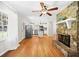 Inviting living room with stone fireplace, hardwood floors, and an open view into the kitchen, perfect for entertaining at 3087 Meadow Lark Ln, East Point, GA 30344