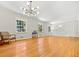 Bright, spacious living room featuring beautiful hardwood floors and modern lighting at 3087 Meadow Lark Ln, East Point, GA 30344