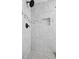 Shower showcasing modern design with white marble tiles, a rainfall showerhead, and a built-in niche for storage at 3087 Meadow Lark Ln, East Point, GA 30344