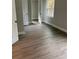 A bright bedroom with hardwood floors, closet, and a large window at 316 Henry Aaron Ave, Atlanta, GA 30310