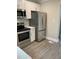 Contemporary kitchen showcases stainless steel appliances and sleek white cabinets for storage at 316 Henry Aaron Ave, Atlanta, GA 30310