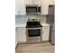 Well equipped kitchen with stainless steel oven, microwave and sleek countertops at 316 Henry Aaron Ave, Atlanta, GA 30310