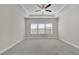 Bright bedroom featuring plush carpet, tray ceiling, and a modern ceiling fan at 814 Spruce Ave, Canton, GA 30114