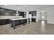 An open-concept kitchen features an island, stainless appliances, black cabinets and gray backsplash at 814 Spruce Ave, Canton, GA 30114