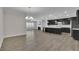 A kitchen and living room open concept features stainless steel appliances and lots of light at 814 Spruce Ave, Canton, GA 30114