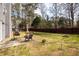 A spacious fenced backyard includes a patio with furniture, landscaping, and fire pit at 2690 Manassas Pl, Snellville, GA 30039