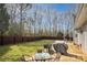 Spacious fenced backyard with outdoor seating and a grill, perfect for entertaining at 2690 Manassas Pl, Snellville, GA 30039