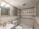 Full bathroom featuring neutral tiling, toilet, shower and a vanity sink at 2690 Manassas Pl, Snellville, GA 30039