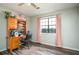 This bedroom features a desk, window, and hardwood flooring at 2690 Manassas Pl, Snellville, GA 30039
