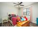 Bedroom with a ceiling fan, a trunk full of toys, and light-toned walls at 2690 Manassas Pl, Snellville, GA 30039