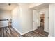 Hallway with hardwood floors leading to an open room with fireplace at 2690 Manassas Pl, Snellville, GA 30039