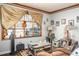 Cozy living room featuring a large window with decorative curtains and hardwood floors at 2690 Manassas Pl, Snellville, GA 30039