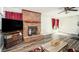 Large living room featuring a brick fireplace, hardwood flooring, and a sliding glass door at 2690 Manassas Pl, Snellville, GA 30039