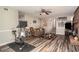 Spacious living room featuring hardwood floors, brick fireplace, stairs, and ceiling fan at 2690 Manassas Pl, Snellville, GA 30039