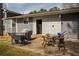 A patio includes a grill, table with chairs, and entrance to the rear of the house at 2690 Manassas Pl, Snellville, GA 30039