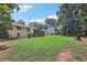 Expansive backyard featuring a lush lawn and mature trees, perfect for outdoor activities at 3231 Boulder Brook Dr, Lithonia, GA 30038