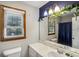 Charming bathroom featuring a large mirror, ample natural light, and a decorative light fixture at 3231 Boulder Brook Dr, Lithonia, GA 30038