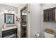 Modern bathroom with stylish vanity, glass shower, and built-in storage cabinet at 3231 Boulder Brook Dr, Lithonia, GA 30038