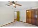 This bedroom features comfortable carpeting, a ceiling fan, and a spacious closet for ample storage at 3231 Boulder Brook Dr, Lithonia, GA 30038