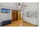 This bright bedroom has hardwood floors, a mounted television, a ceiling fan, and plenty of storage at 3231 Boulder Brook Dr, Lithonia, GA 30038