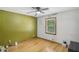 A sunlit bedroom with wood floors, a ceiling fan, and large windows for natural light at 3231 Boulder Brook Dr, Lithonia, GA 30038
