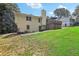Side view of home with a spacious lawn, trees, and large back deck at 3231 Boulder Brook Dr, Lithonia, GA 30038