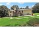 Rear exterior featuring a wooden deck and a well-maintained lawn at 3231 Boulder Brook Dr, Lithonia, GA 30038