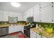 Featuring white cabinets, modern appliances, and bright countertops, this kitchen offers both style and functionality at 3231 Boulder Brook Dr, Lithonia, GA 30038