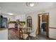 Eat-in kitchen features white cabinets and views to laundry area at 3231 Boulder Brook Dr, Lithonia, GA 30038