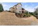 Multi-story home with a backyard featuring manicured landscaping and a charming stone stairway at 4070 Preserve Crossing Ln, Cumming, GA 30040