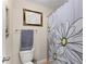 Cozy full bathroom featuring a framed print and a shower with a floral curtain at 4070 Preserve Crossing Ln, Cumming, GA 30040