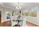 Bright breakfast nook featuring a chandelier, a glass table, and backyard views at 4070 Preserve Crossing Ln, Cumming, GA 30040