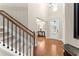 Bright foyer features a soaring ceiling, hardwood floors, and a view of the staircase at 4070 Preserve Crossing Ln, Cumming, GA 30040