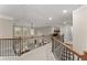 Second story hallway with a decorative banister, carpeted floors, and bedroom views at 4070 Preserve Crossing Ln, Cumming, GA 30040