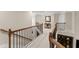 Second story hallway overlooks the lower level, featuring hardwood banisters and carpeted floors at 4070 Preserve Crossing Ln, Cumming, GA 30040