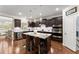 Modern kitchen with a center island, stainless steel appliances, and dark wood cabinets at 4070 Preserve Crossing Ln, Cumming, GA 30040