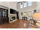 Comfortable living room with a stone fireplace, built-in shelves, and lots of natural light at 4070 Preserve Crossing Ln, Cumming, GA 30040