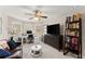 Bright living room features a ceiling fan, bay windows, and a cozy seating area at 4070 Preserve Crossing Ln, Cumming, GA 30040